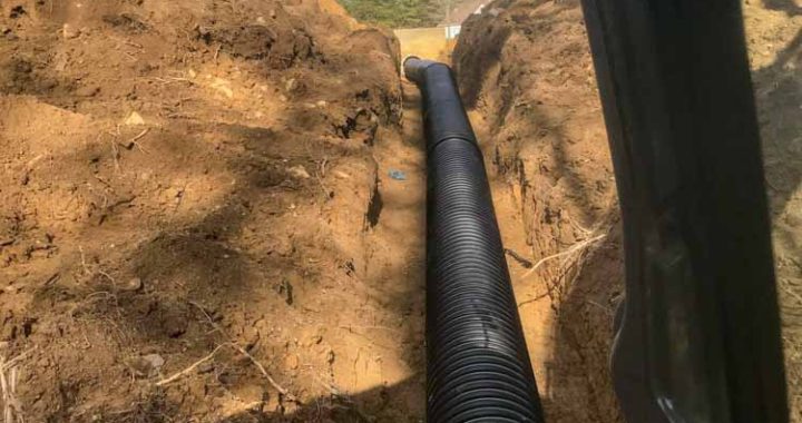 Drainage solution involving excavation and grading for proper installation and flow